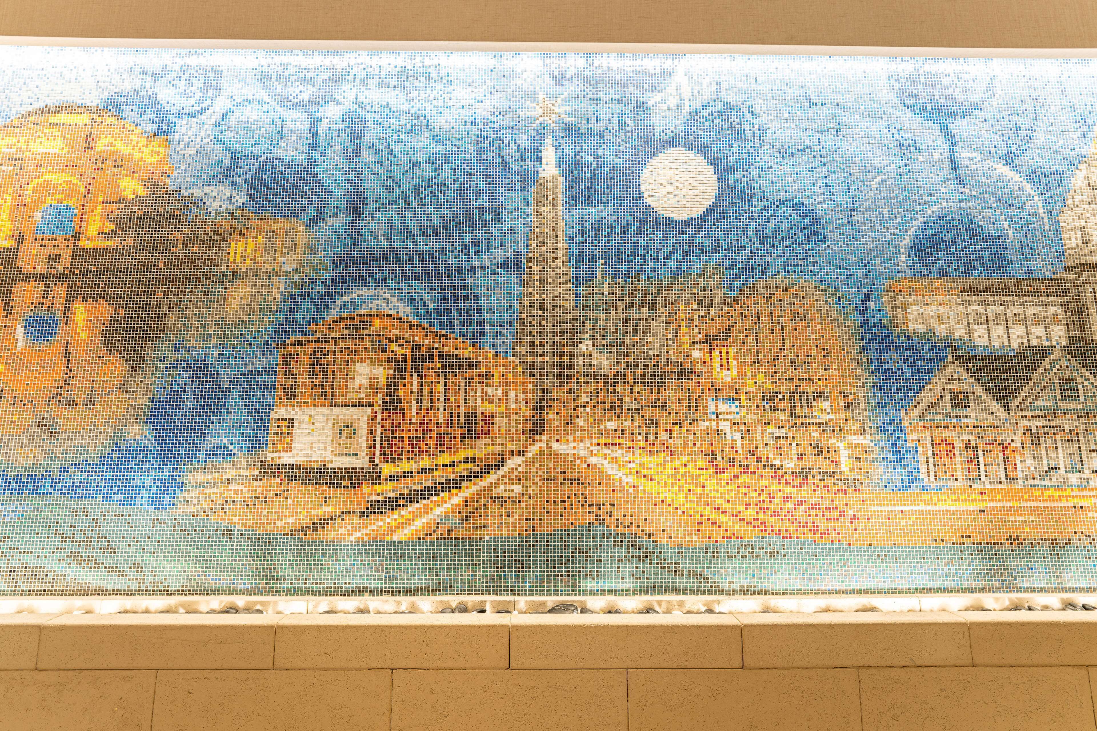 A mosaic artwork depicting a night scene with a prominent tower and a full moon.