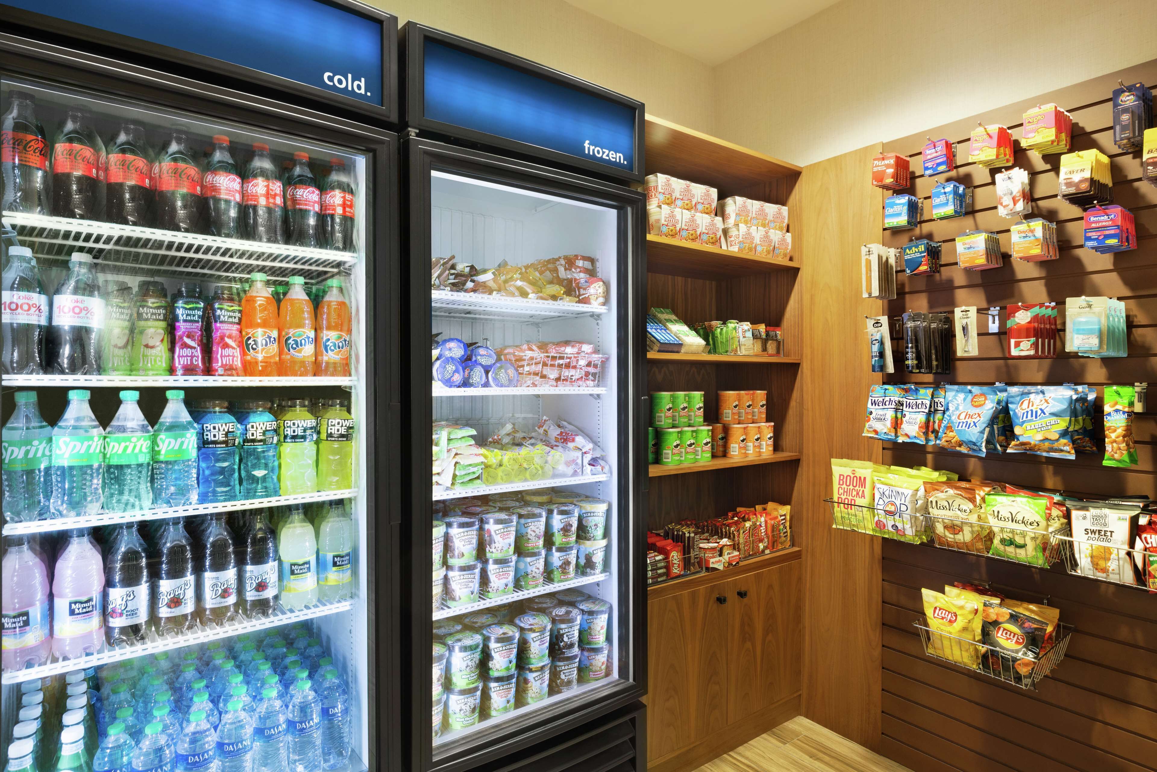 A refrigerated display with various beverages and snacks.
