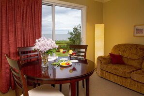 Superior Room 1 King Bed and Sofa Bed-Annex Building West, Ground Floor, Sea view and Balcony | Living area | Flat-screen TV - Hôtel Motel Belle Plage (Matane)