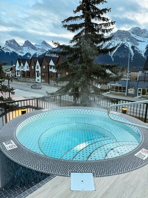 Relax by the pool surrounded by a unique tiled design and stunning mountain views.