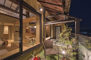 A modern interior with a glass wall, a dining area with a table and chairs, and a staircase leading to an upper level. - Wakasa Bettei (Nara)