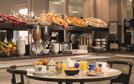 A breakfast buffet with various food items and beverages.