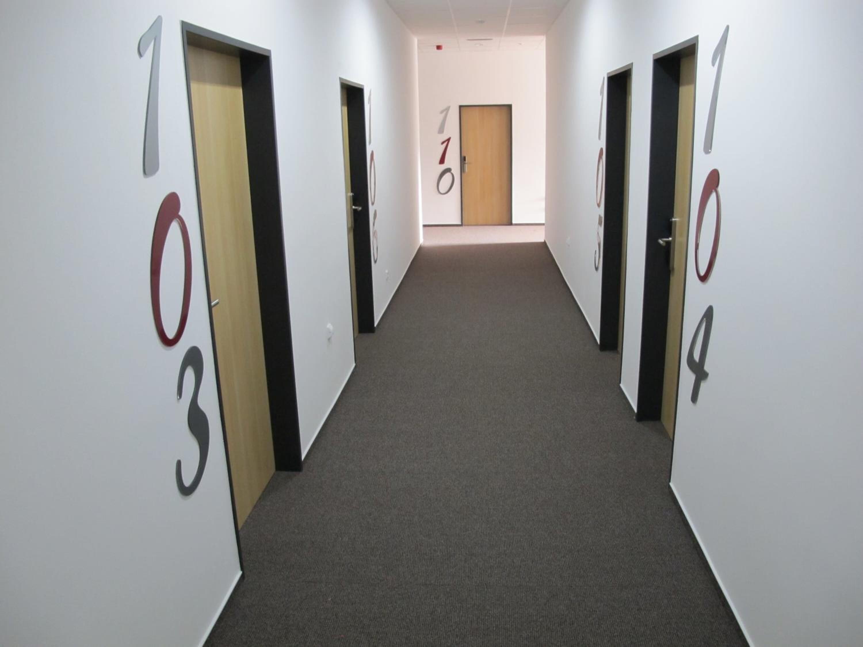 A hallway with doors numbered 1 to 4.
