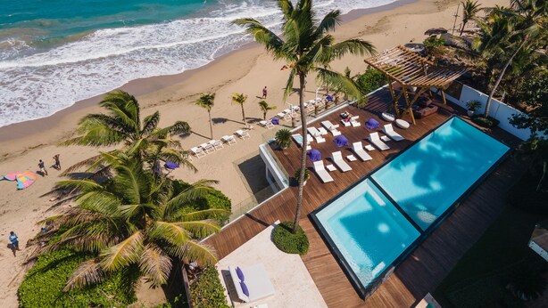 A resort with a pool, beach, and palm trees. - Ultravioleta Boutique Residences (Cabarete)