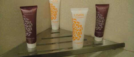 Four Lisan hair care products on a metal shelf.