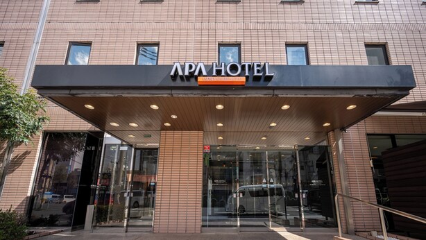 The entrance of APA Hotel with a modern design, featuring a glass facade and a covered entrance area. - APA Hotel Maebashieki-Kita (Maebashi)