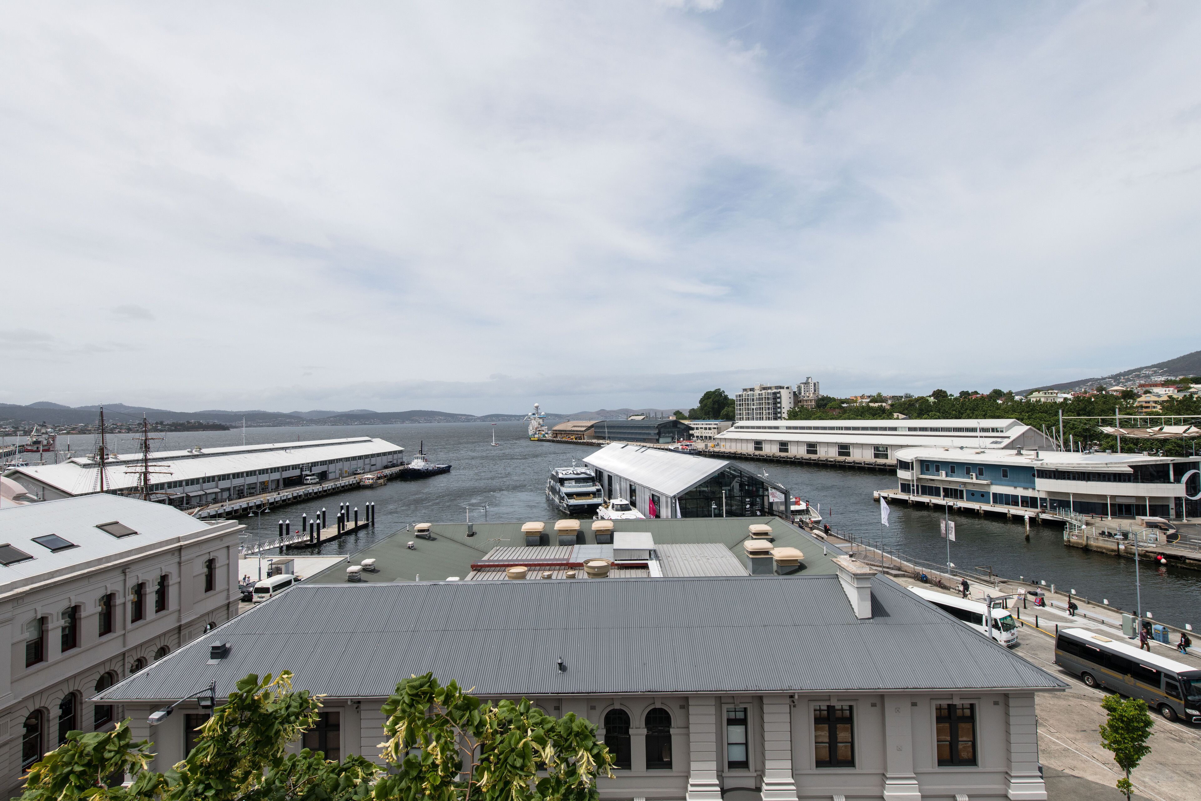 A waterfront building with a flat roof, large windows, and a view of the water.
