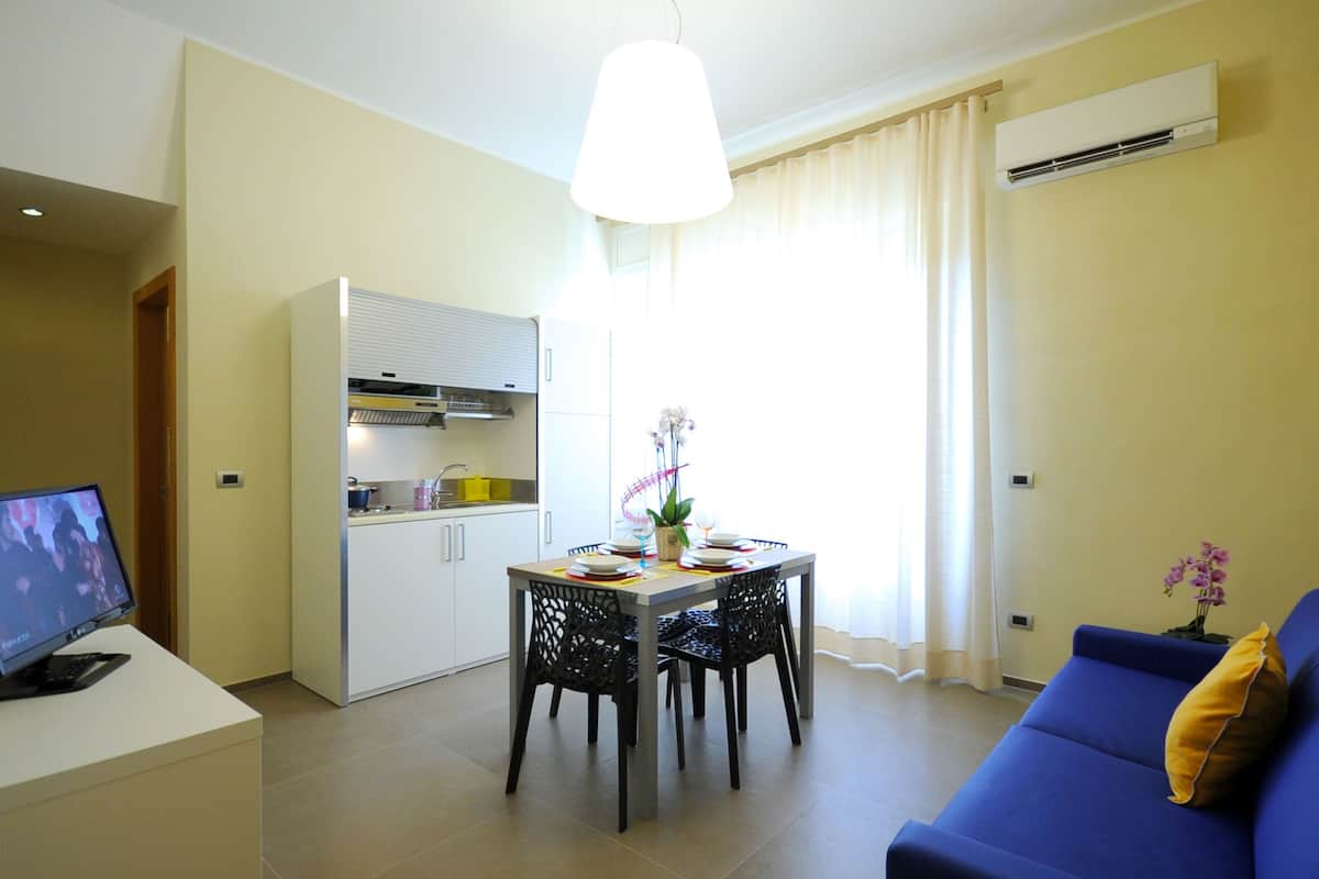 superior apartment, balcony | living area | flat-screen tv