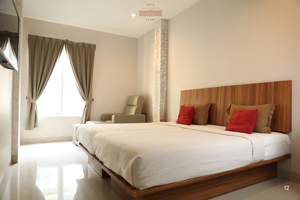 A modern bedroom with a large bed, a wooden headboard, and a chair.