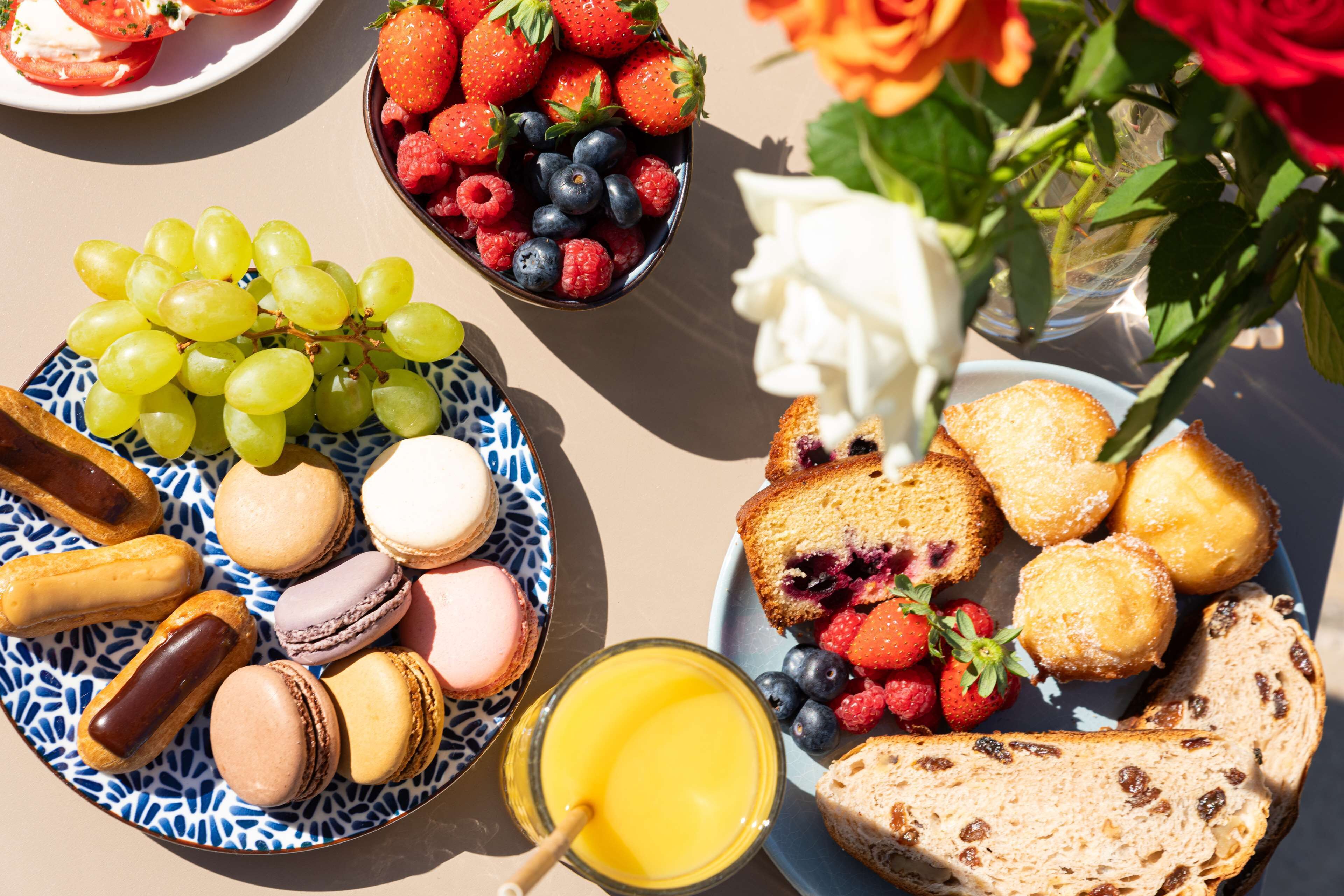 A breakfast spread with fruits, pastries, and bread.