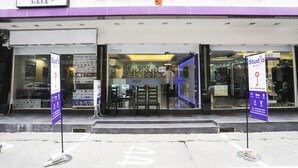 A storefront with the sign "Studio Nana" and a large key logo. - Studio Nana (Bangkok)