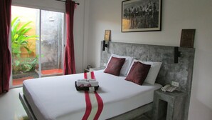 A hotel room with a bed, a nightstand, a telephone, and a window with curtains. - The Park Drive-Thru Check-In Resort (Thanyaburi)