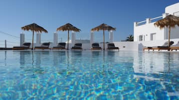Seasonal outdoor pool, open 9 AM to 9 PM, pool umbrellas, pool loungers