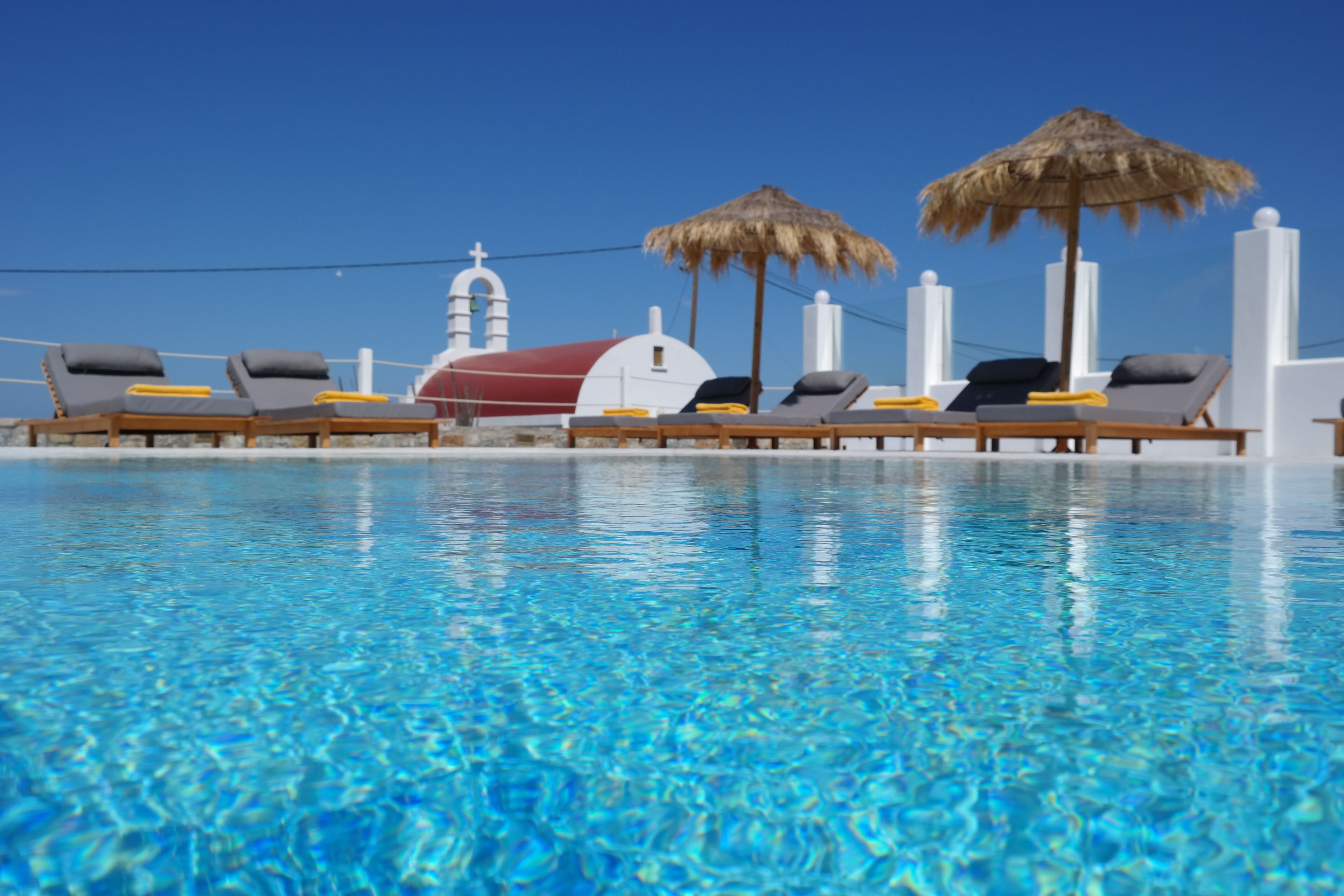 seasonal outdoor pool, open 9 am to 9 pm, pool umbrellas, pool loungers