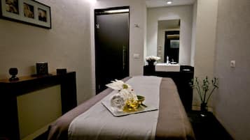 Relax in a serene space with a comfortable bed, bedside table, and wall-mounted TV.