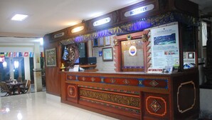 A reception desk with a sign indicating 'ROOM KEY' and 'INFORMATION'. - Hotel Sorga (Kuta)