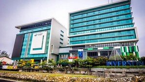 A modern building with multiple floors, large glass windows, and a prominent sign for 'Everston'. - KK Times Square Hotel (Kota Kinabalu)