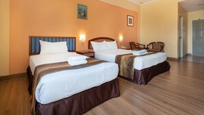 A hotel room with two beds, wooden flooring, and a door leading to a hallway. - Hotel Seri Malaysia Ipoh (Ipoh)