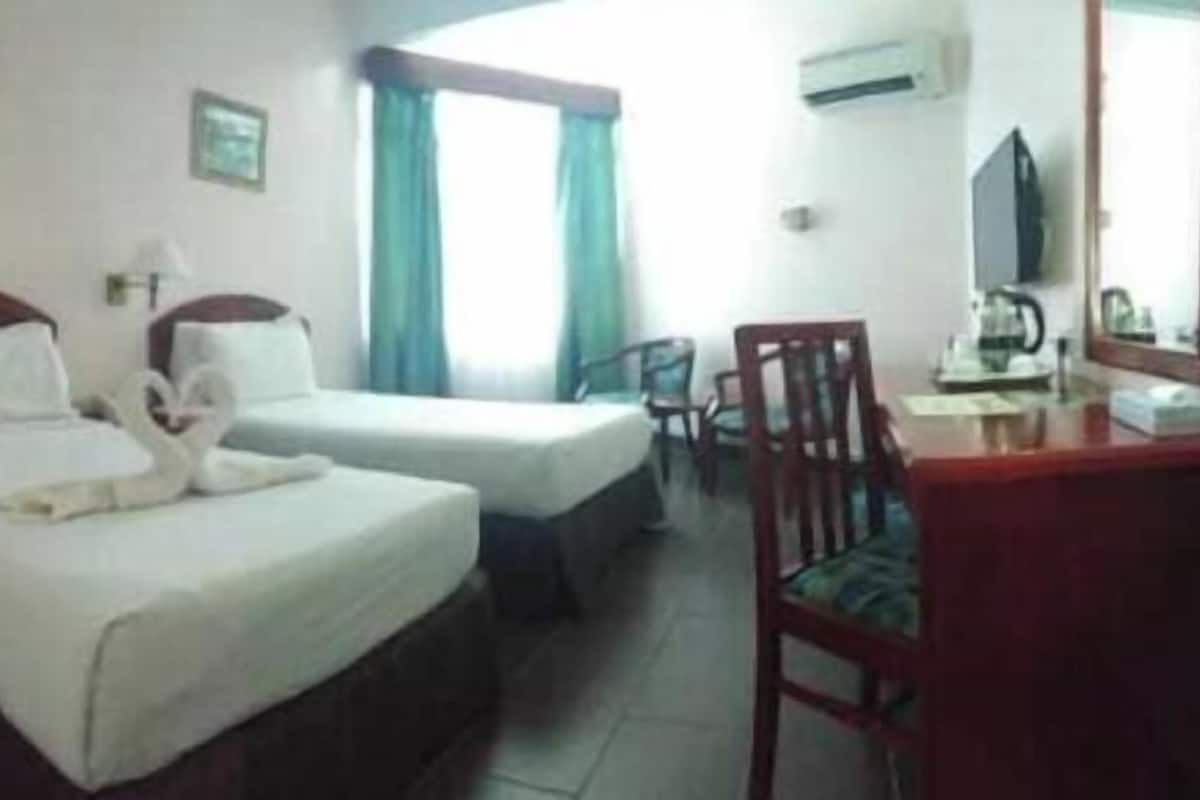 Minibar, desk, bed sheets