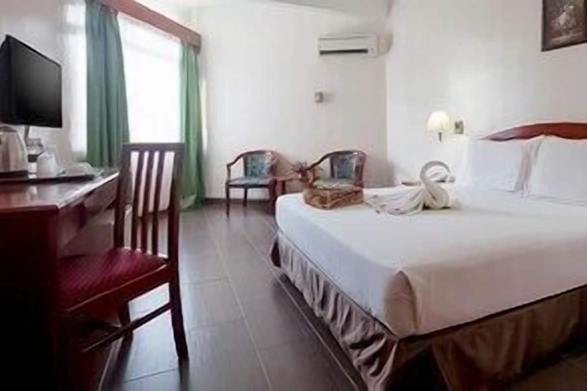 Minibar, desk, bed sheets