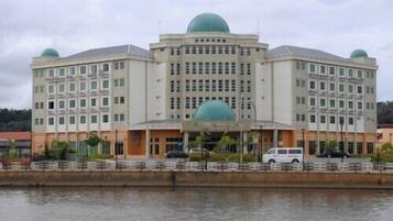 A large, multi-story building with a central dome and smaller domes on the corners.
