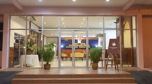 A hotel entrance with glass doors, a reception desk, and potted plants. - Hotel Seri Malaysia Seremban (Seremban)