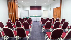 A conference room with rows of red chairs, a white table with a green tablecloth, and a whiteboard. - Hotel Seri Malaysia Seremban (Seremban)