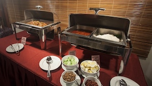 A buffet setup with various food items including a bowl of salad, a bowl of eggs, and a container of rice. - Hotel Seri Malaysia Seremban (Seremban)