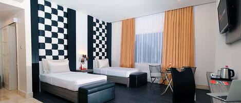 A modern hotel room with two beds, a desk, a chair, and a TV.