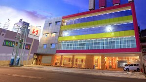 A multi-story hotel with a modern design, featuring a prominent entrance with glass doors and a visible reception area. - Swiss-Belcourt Makassar (Makassar)