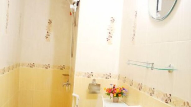 A bathroom with a toilet, bidet, sink, and a mirror. - Donmuang - Impact Condo Service (Pak Kret)