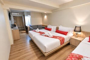 A hotel room with a large bed, a desk, and a chair. -  Wild Orchid Villa Bangkok (Bangkok)