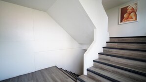 A staircase with wooden steps and white walls. -  Wild Orchid Villa Bangkok (Bangkok)