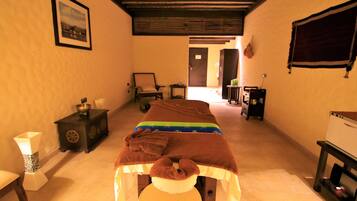 Relax in this serene space, featuring a massage table and a peaceful atmosphere.