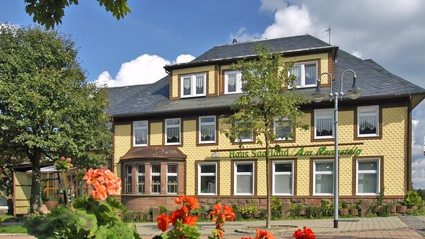 A two-story hotel with a brick facade and multiple windows.