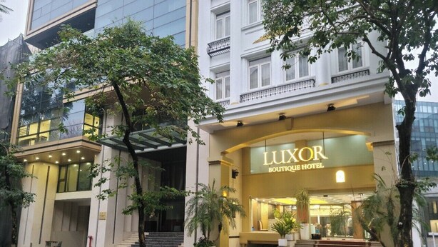 A hotel entrance with a sign reading "LUXOR BOUTIQUE HOTEL". - Luxor Boutique Hotel (Hanoi)
