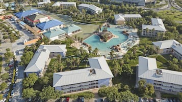 Resort area with multiple buildings, a central pool, and landscaped gardens.
