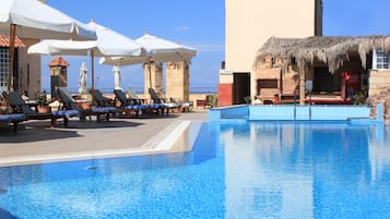 Seasonal outdoor pool, open 10:00 AM to 6:00 PM, pool loungers