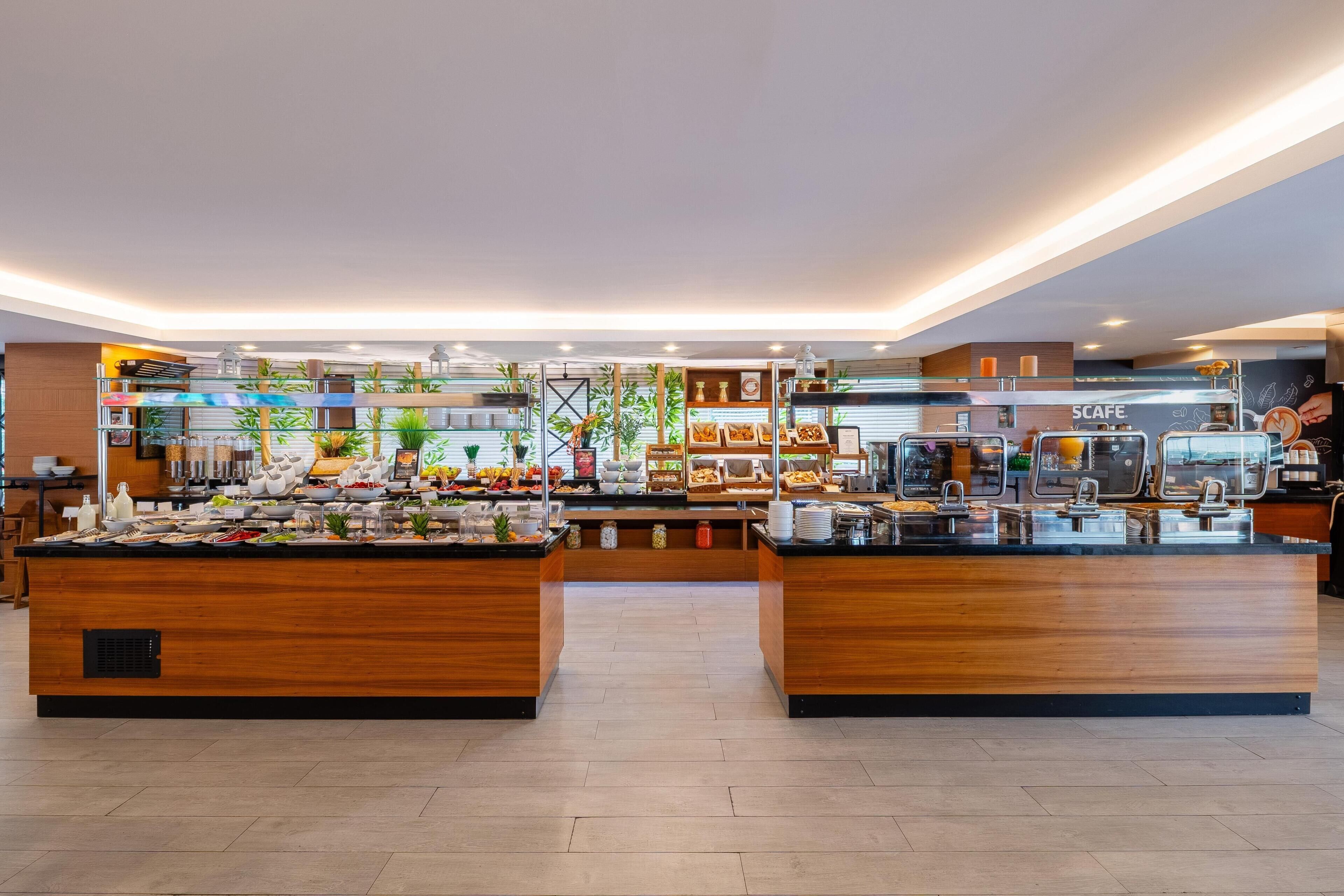 A buffet area with various food stations and a coffee bar.