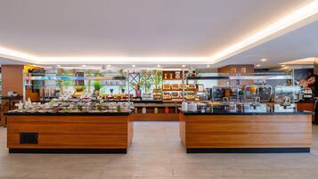 A buffet area with various food stations and a coffee bar.