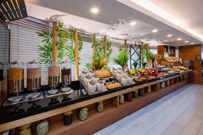 A buffet setup with various food items and condiments. - Park Inn by Radisson Istanbul Asia Kavacik (Beykoz)