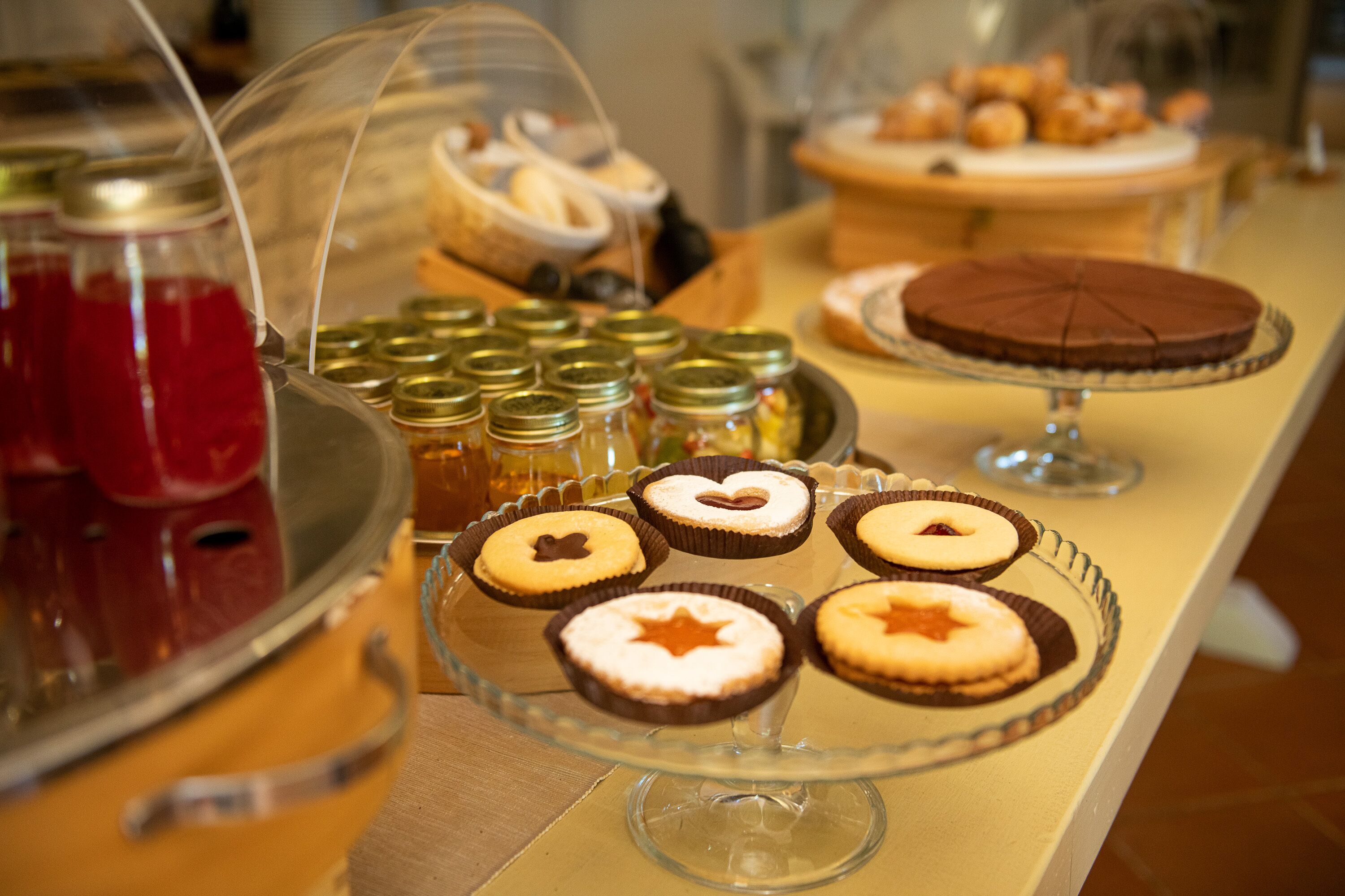 A buffet with various desserts including cakes and pastries.