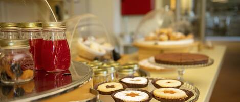 A buffet with various desserts and beverages.