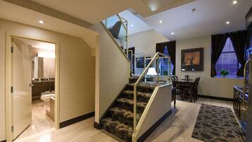 A modern interior with a staircase, a dining area, and a kitchen.