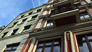 A multi-story building with a classic architectural style, featuring large windows and decorative moldings. - SleepWalker Boutique Suites (Wroclaw)