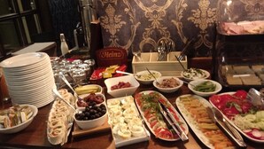A buffet table with various dishes and condiments. - SleepWalker Boutique Suites (Wroclaw)