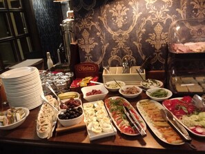 A buffet table with various dishes and condiments. - SleepWalker Boutique Suites (Wroclaw)