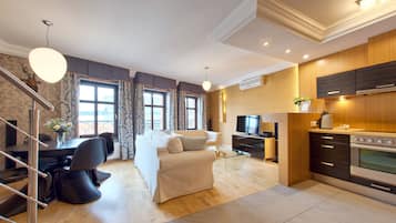 Departamento Deluxe, 2 habitaciones | Sala de estar | Televisión LCD de 42 pulgadas con canales vía satélite y televisión