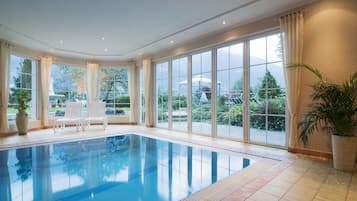 Indoor pool, pool umbrellas, pool loungers