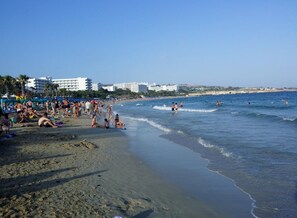 Vlak bij het strand, ligstoelen aan het strand, parasols